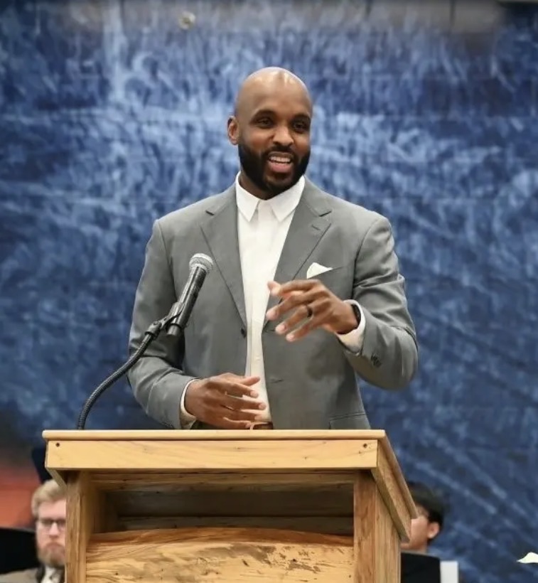Omari Pearson speaking at a podium